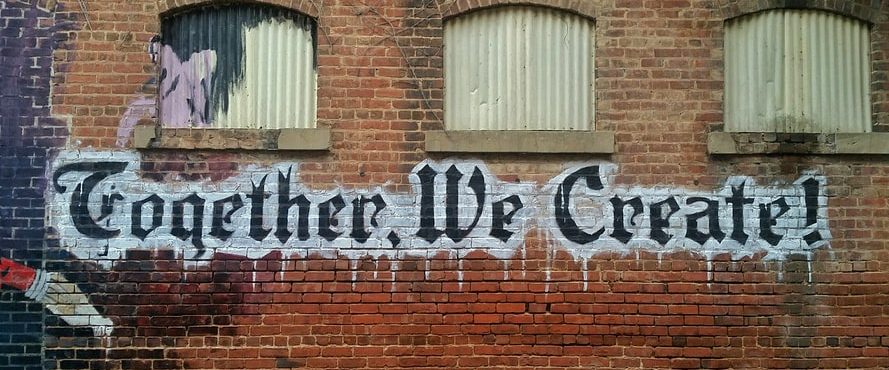 “Together, We Create!” On Brick Wall