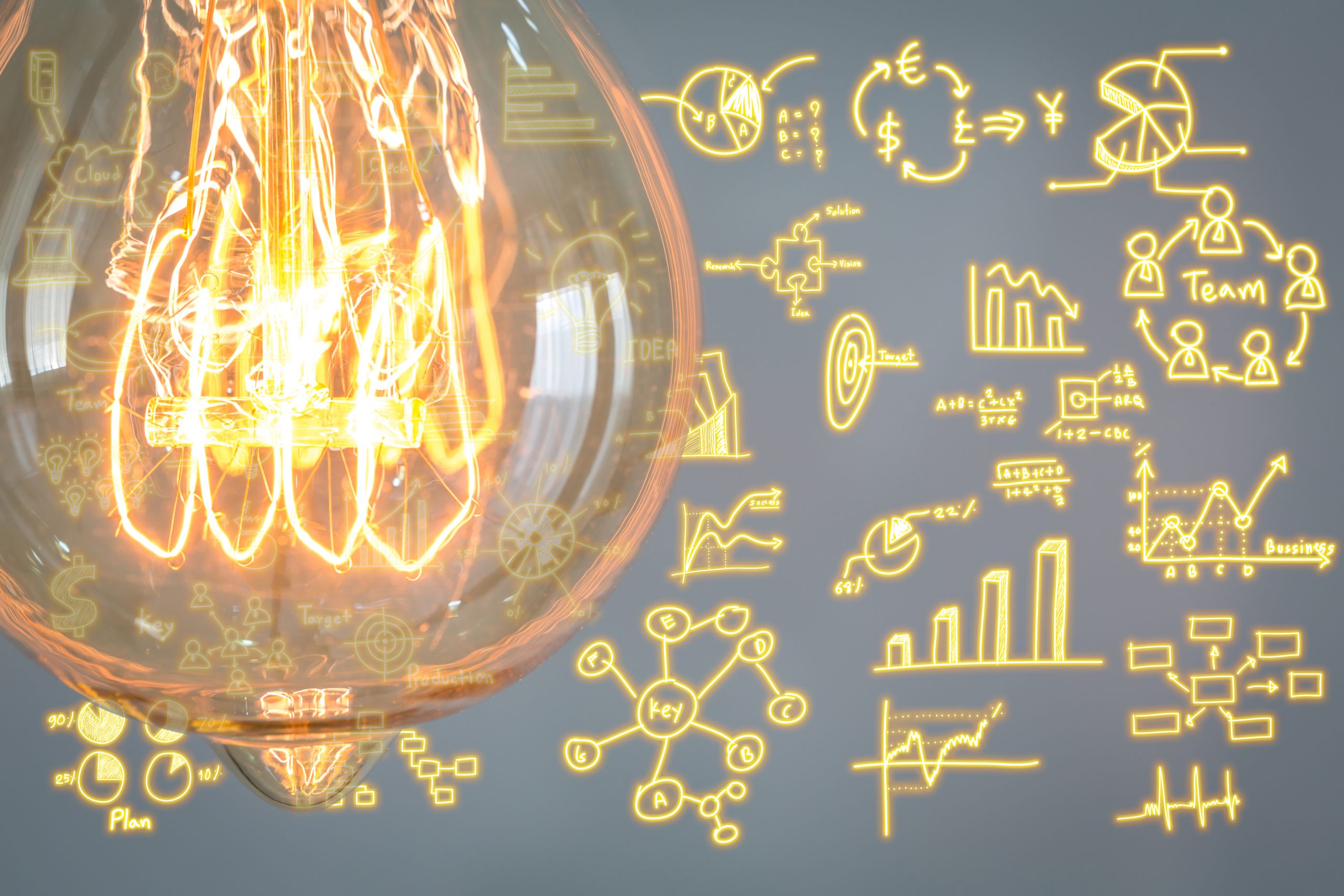 Close Up Of Vintage Glowing Light Bulb With Business Graph